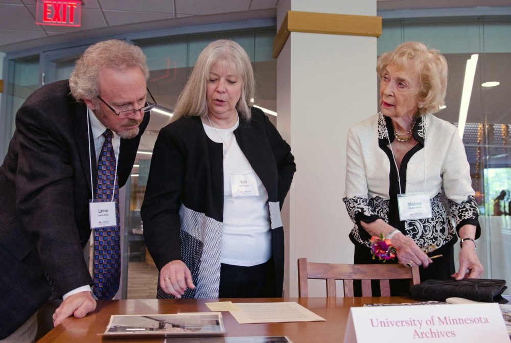 Maxine Wallin, right, browses through historical materials at the opening of the Maxine Houghton Wallin Special Collections Research Center on May 13, 2018. With her are her son Lance and Kris Kiesling, Director of the Libraries Archives and Special Collections.