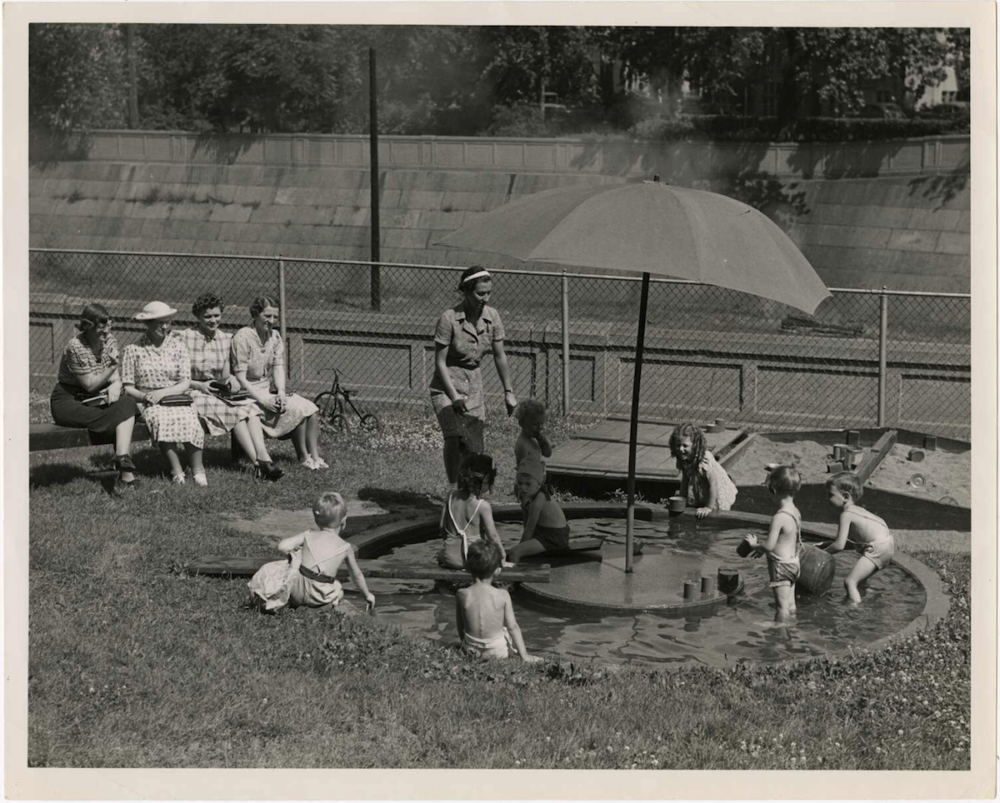 Children attending the University Nursery School play in a wading pool while being observed, 1939.