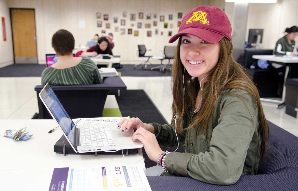 Student with laptop studying in Wilson Library.