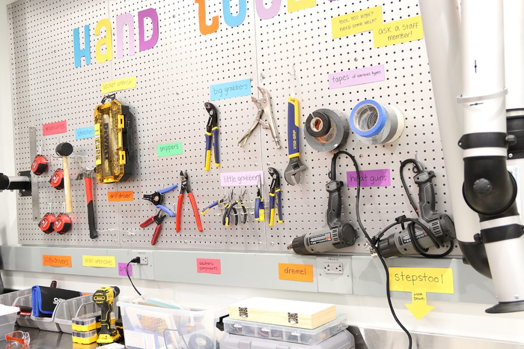 the wall of labeled hand tools in the Makerspace