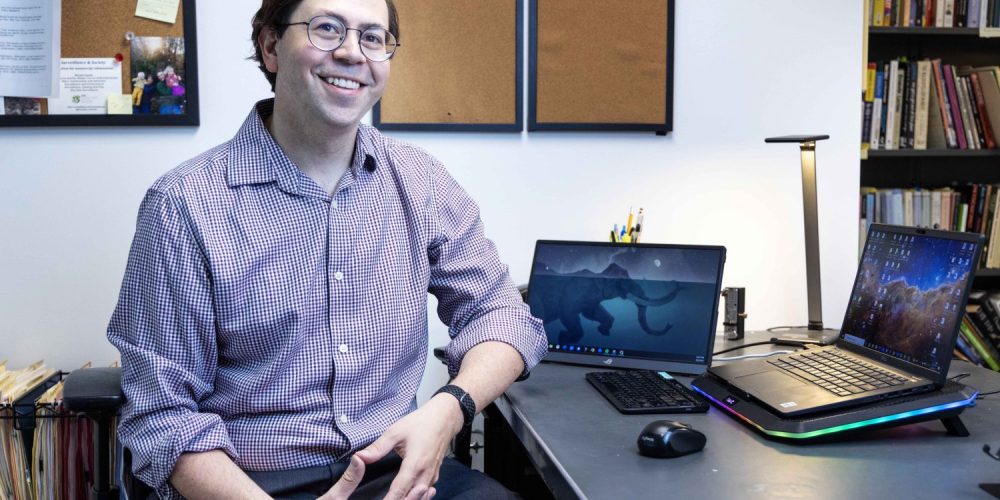 Atilla Hallsby, associate professor in the communication studies department at the University of Minnesota, poses for a portrait on Thursday, Aug. 3, 2023. Hallsby is author of the open-access textbook, "Reading Rhetorical Theory," published with the help of the UMN LIbraires' Partnership for Affordable Learning Materials. (Photo/Adria Carpenter)