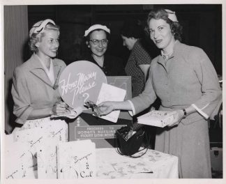 Volunteers from the Mount Sinai Hospital Women’s Auxiliary sell their cookbook at a fundraising event, circa 1955