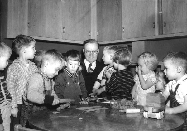 John E. Anderson served as the first Director of the Institute of Child Welfare (1925-1954) and is pictured with children at the Institute in 1955. http://purl.umn.edu/81735.