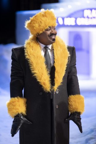Man in a handsome coat with yellow faux fur cuffs, lapels, and hat