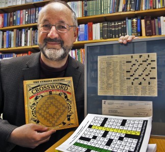 U of M chemistry professor George Barany is a cross word puzzle fan, creating many new puzzles and winning puzzle contests. Here he displays a book showing the first cross word puzzle created in 1913, as well as a display of his first NYT puzzle including the dollar he kept from the prize money. MARLIN LEVISON/STARTRIBUNE (mlevison@startribune.com)
