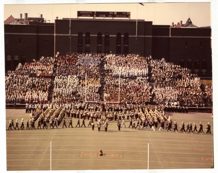 High School Band Day with University Marching Band in block “M” formation, 1975, available at http://brickhouse.lib.umn.edu/items/show/46 (And who is that at the 50-yard line enjoying the performance?)