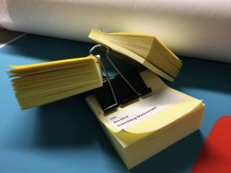 Photo of three stacks of Post-It Notes with labels of web page titles.