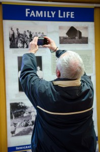 Visitor taking a photo of a display panel in the exhibit.