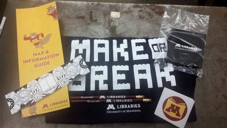 University of Minnesota Libraries map, t-shirt, pencils, sticker, and bookmark.