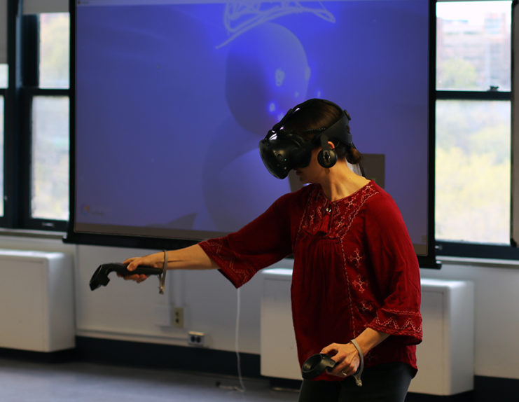Teresa Bisson demonstrating virtual reality