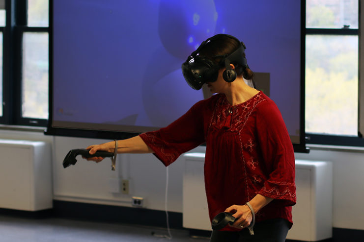 Teresa Bisson demonstrating virtual reality