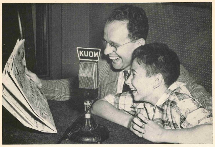 Announcer George Grim with a boy reading the daily comics over the air, 1946.