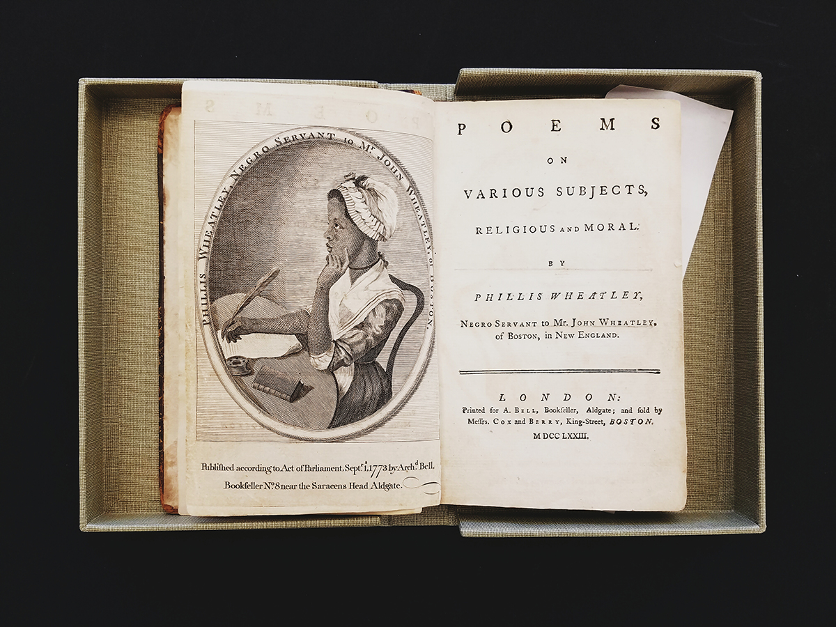 Book spread open. Left side page features an illustration of a woman writing with a quill pen; on the right page reads the title of the work, "Poems on Various Subjects, Religious and Moral" by Phillis Wheatley.