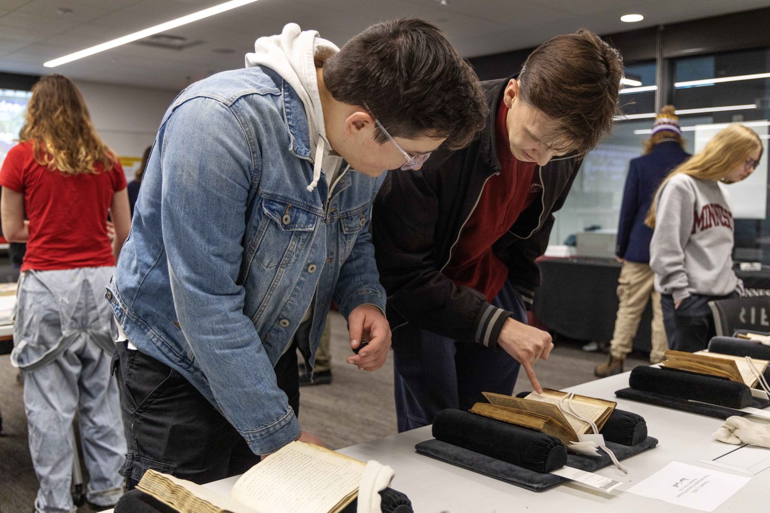 Students read rare books at the Wangensteen pop-up exhibit.