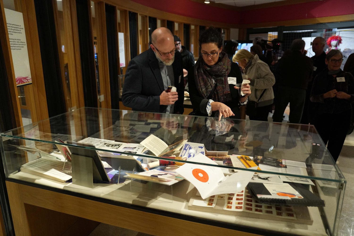 Attendees browse the display cases at the opening of PAA's "Dance Roots" exhibit, on Oct. 27, 2023. Exhibit designed by Darren Terpstra. (Photo/Luke Logan)