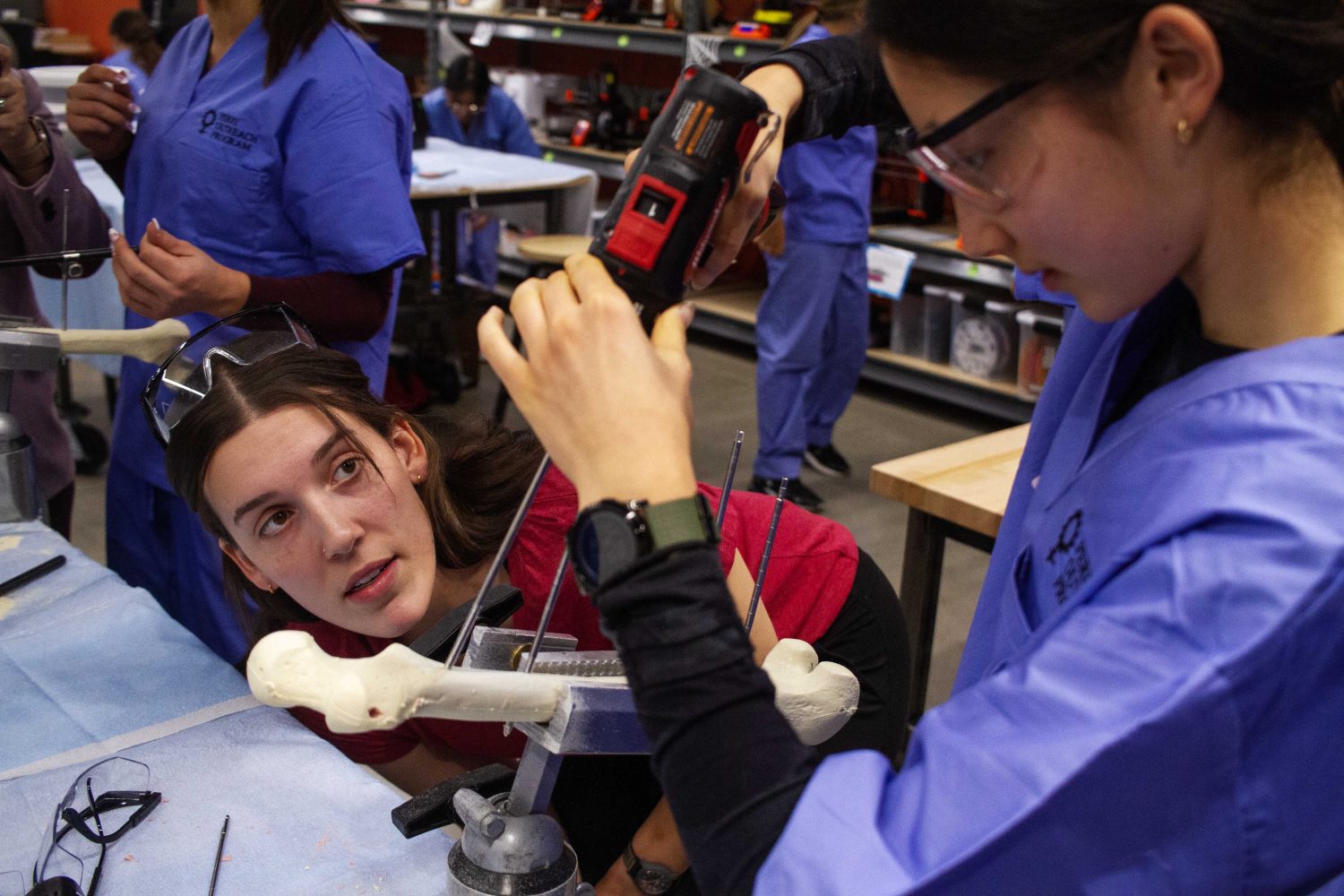 Students practice repairing a fractured femur with medal rods, on Saturday, Oct. 28, 2023. (Photo/Adria Carpenter)