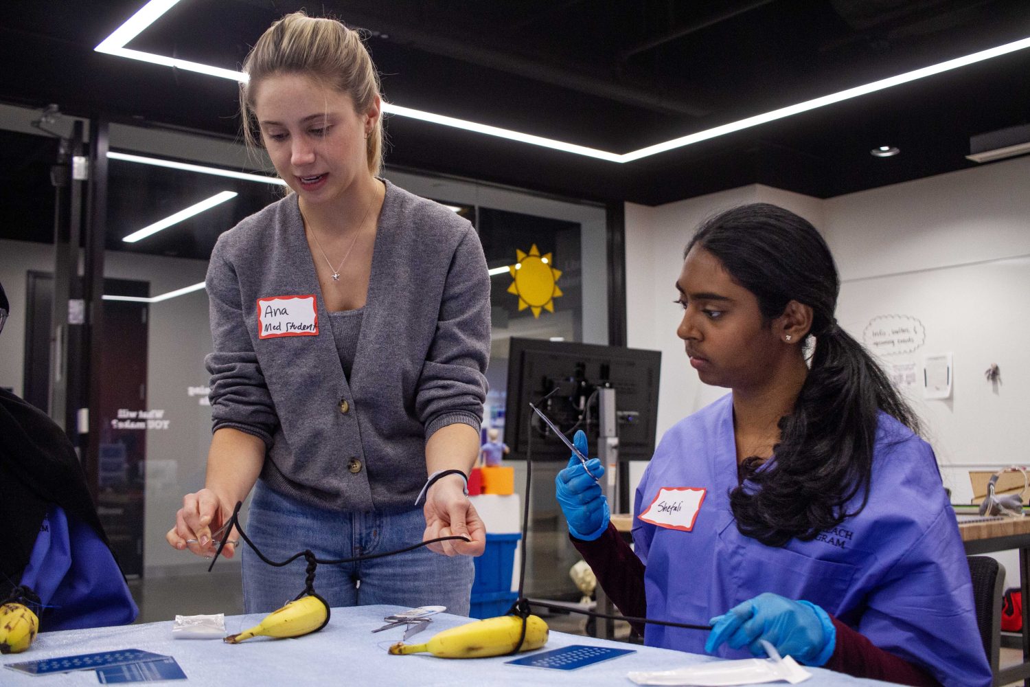 Local high school students learn the techniques behind stitching and practice on a banana, on Saturday, Oct. 28, 2023. (Photo/Adria Carpenter)