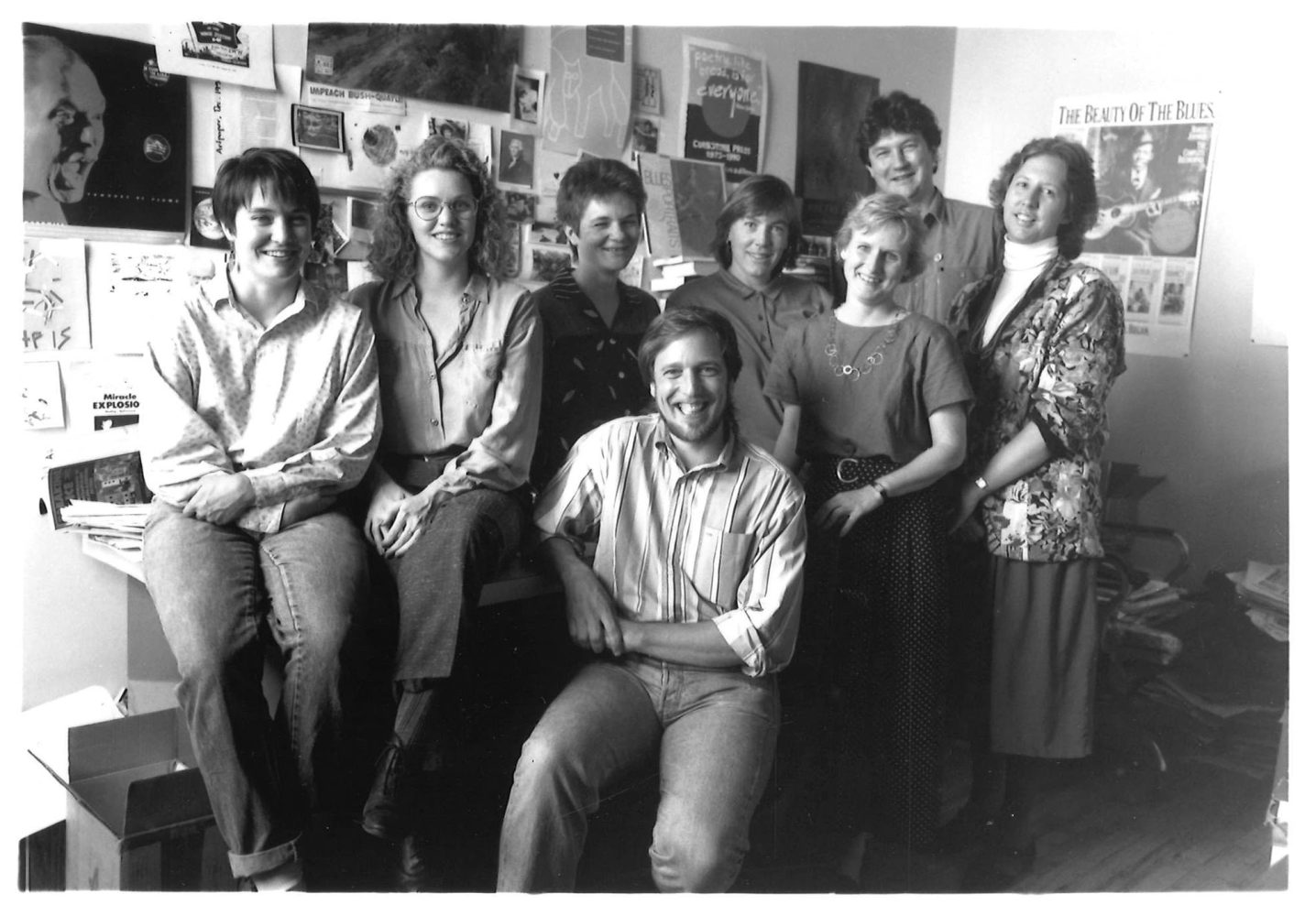 Graywolf Press staff in their St. Paul office. From left to right: M. Lee, E. Gjere, E. Foos, S. Walker, M. Madison, A. Czarniecki, C. Faatz, B. Milligan. (Photo/Wing Young Huie)