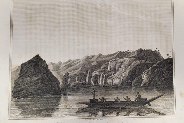 Island profile with canoe in the foreground. Five rowers; one standing on an elevated platform at the front.