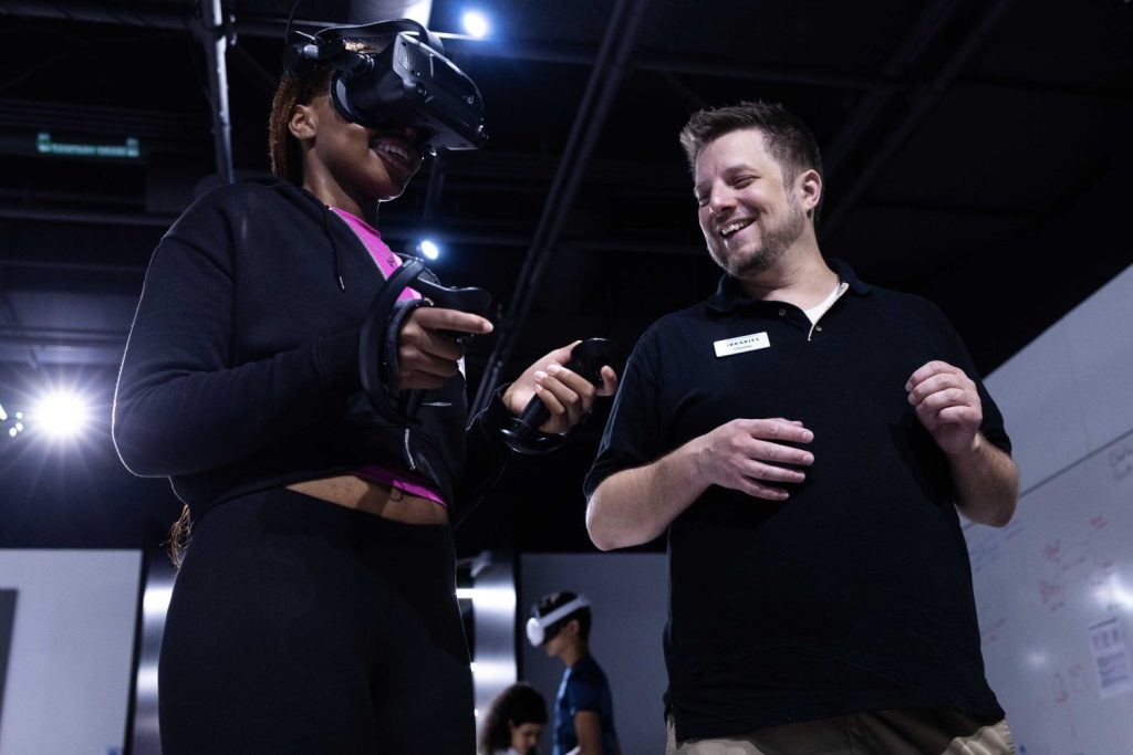 A Twin City high schooler enters the virtual world of science with the help of Charlie Heinz, the VR program lead, during the week-long Go4Brains program, on Wednesday, July 17, 2024. (Photo/Adria Carpenter)