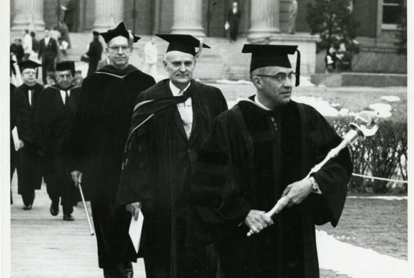 Professor Alfred O. Nier leads University of Minnesota President O. Meredith Wilson in his inauguration procession, February 23, 1961. Nier is carrying the university mace which made its debut during Wilson's inauguration ceremony. University of Minnesota Archives Photograph Collection, https://umedia.lib.umn.edu/item/p16022coll175:15100.