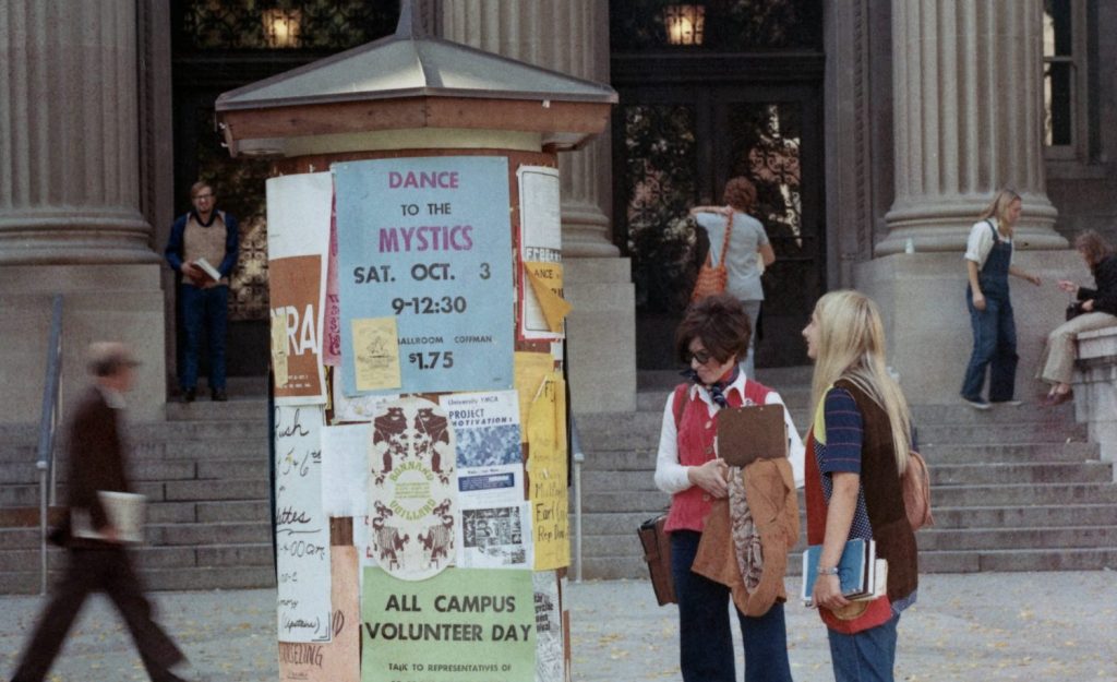 Kiosk in front of Walter Library covered in posters, 1970