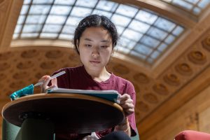 Student studying in Walter Library's Great Hall