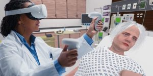 Screenshot of virtual reality experience with two health providers providing care in an emergency room setting.