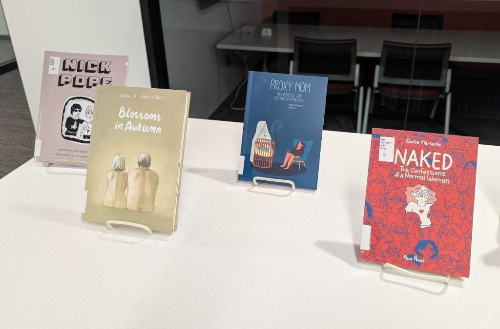 Three graphic novels on display in the Health Sciences Library.