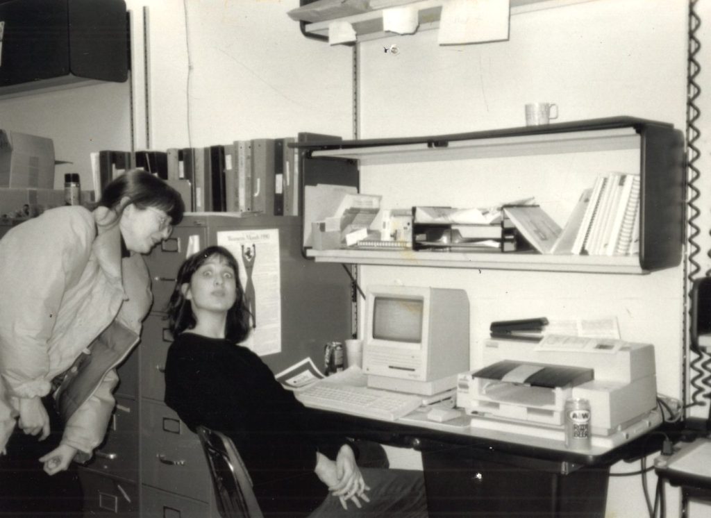 Two women members of the University Young Women (UYW) in their office space.