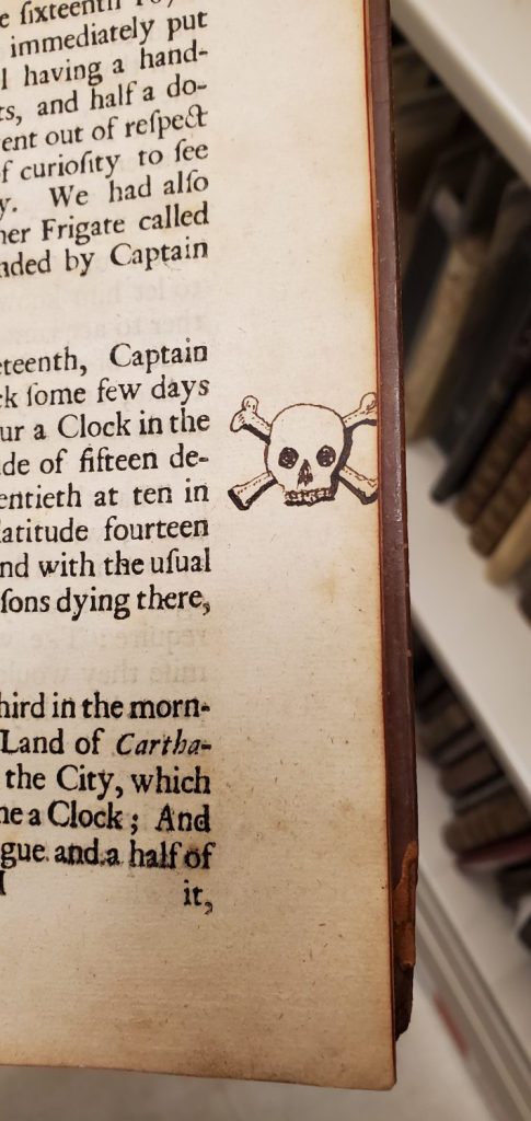 Skull and cross-bones drawn in the margin of a page.