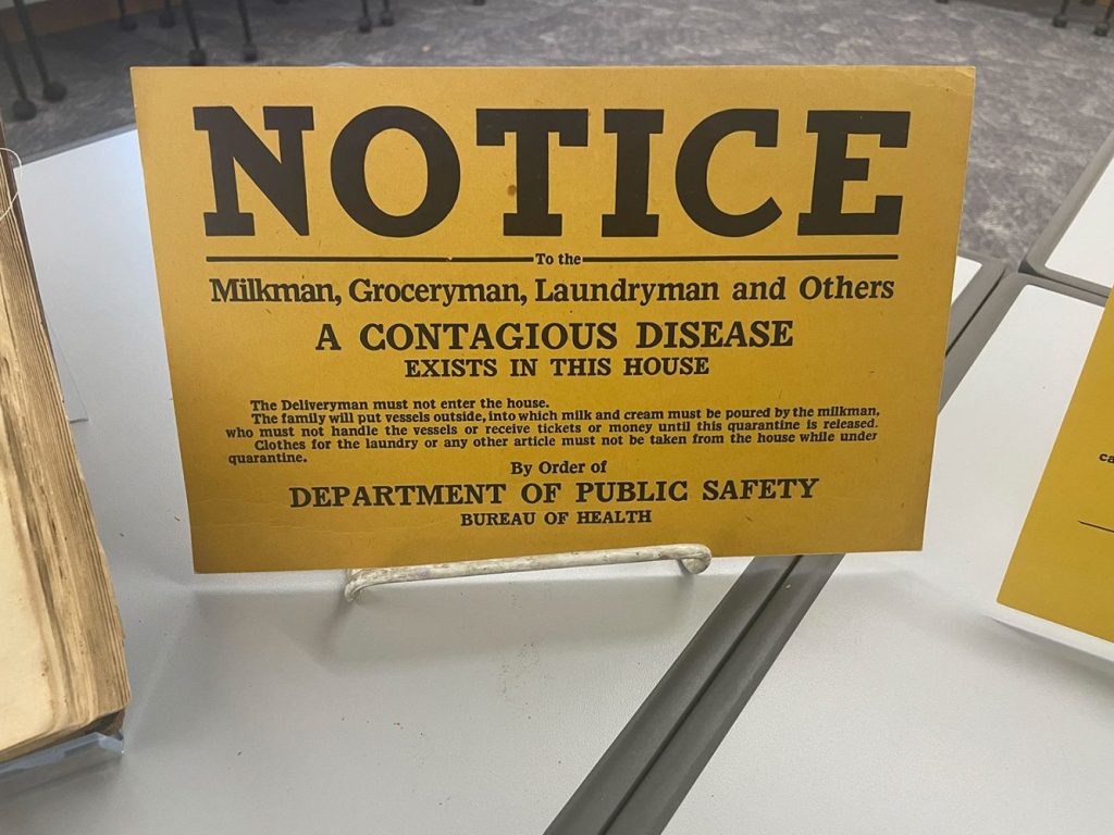 Archival sign that reads "Notice: A contagious disease exists in this house"