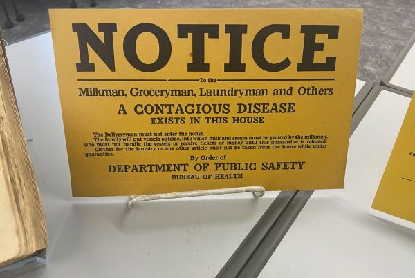 Archival sign that reads "Notice: A contagious disease exists in this house"