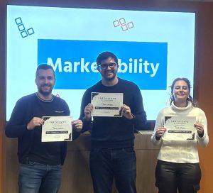 The 3 students that won the Marketability Award poses for a phot.